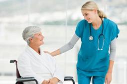 nurse helping patient in wheelchair